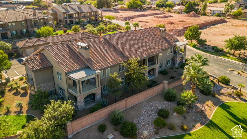 Stucco exterior with multi-level covered balconies, tile roofing, and an attached garage