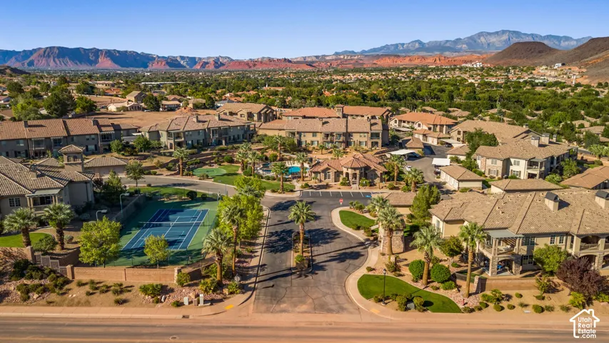 Community featuring a tennis court, swimming pool, and mature landscaping