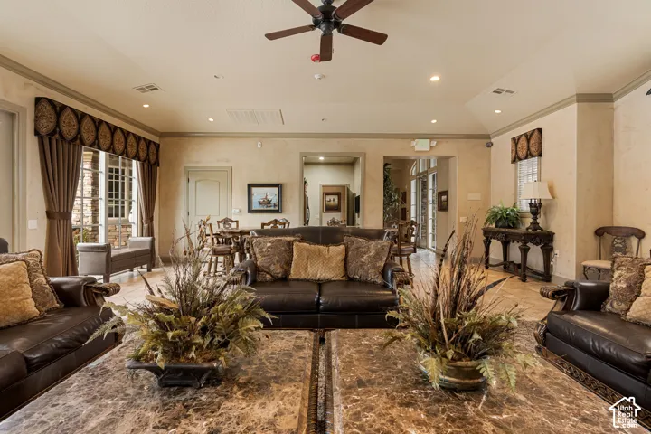 Recessed lighting, ceiling fan, decorative window treatments, tile flooring, and arched entryway
