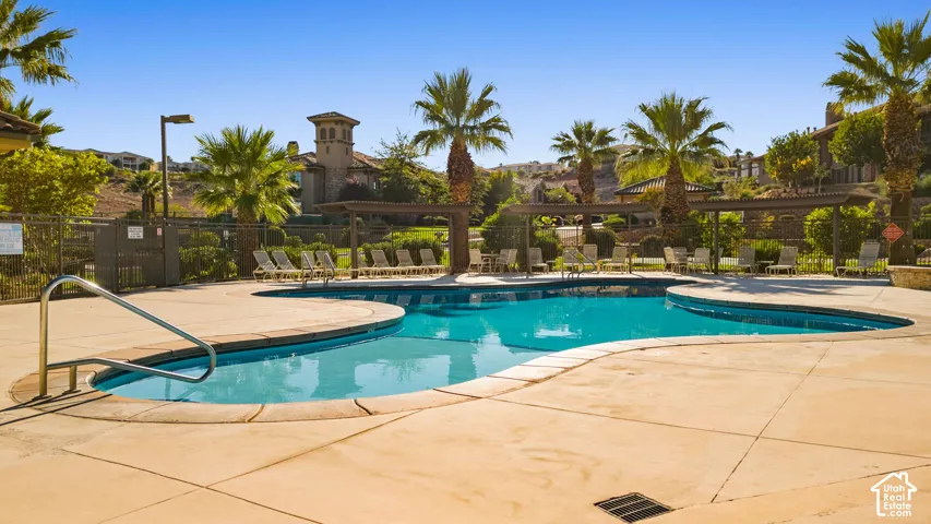 Freeform swimming pool with integrated spa and concrete decking