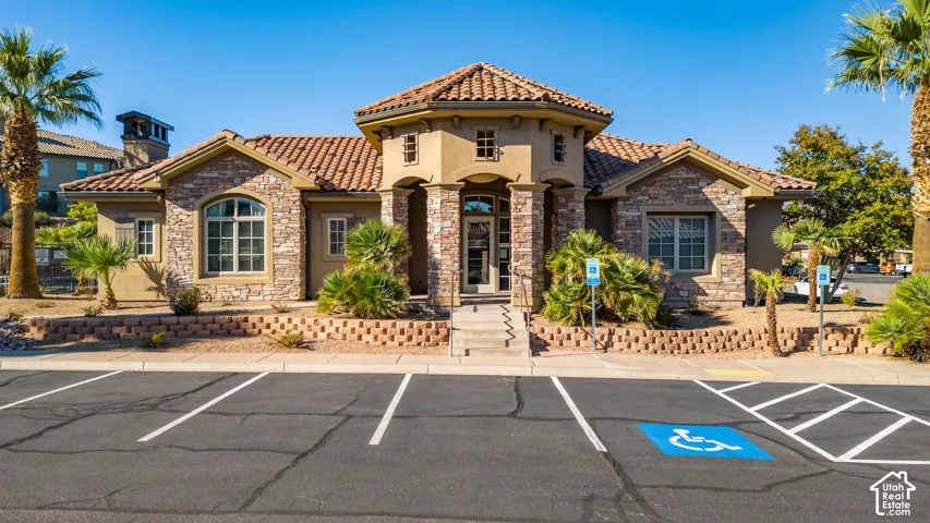 Mediterranean-inspired architecture featuring a terracotta tile roof and stone facade accents