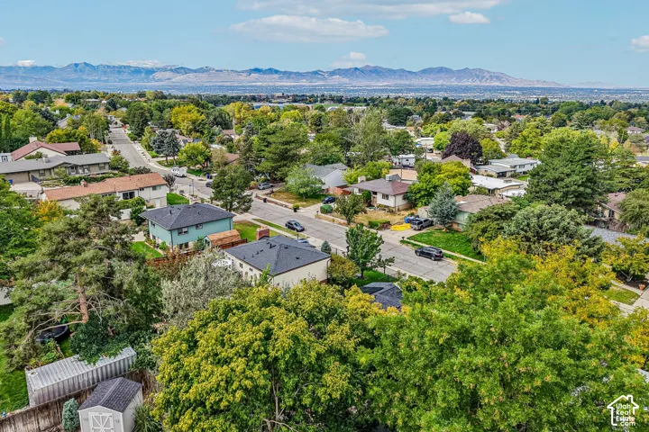 Residential neighborhood with established landscaping and mountain backdrop