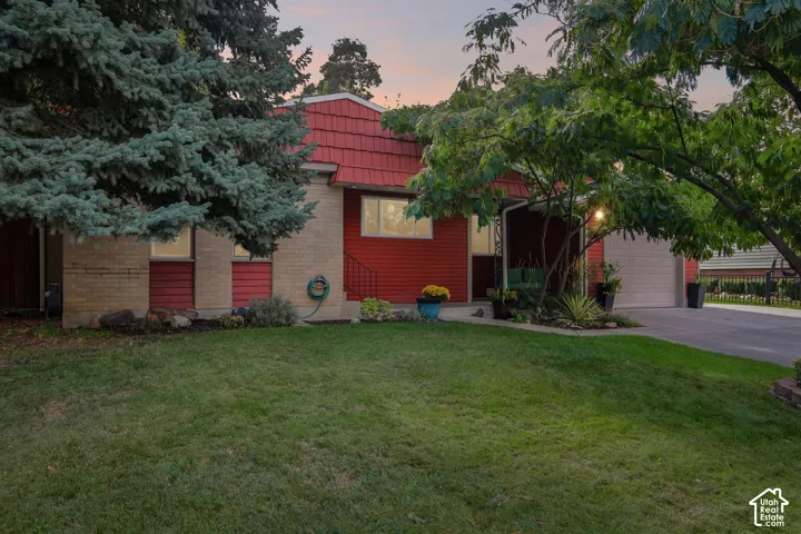 Two-story residence featuring red siding and a red dimensional shingle roof