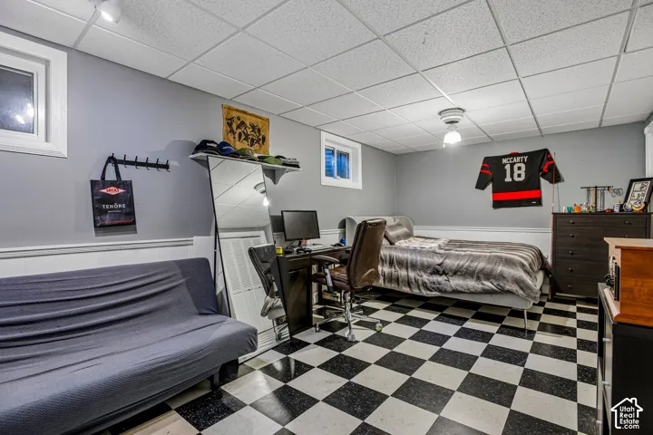 Black and white checkered flooring with white wainscoting and light gray walls
