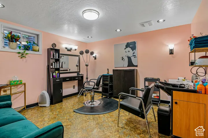 Recessed lighting, wall sconces, window well, built-in cabinetry, and wood-finish flooring
