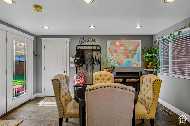Recessed lighting, tile flooring, and multiple doors with white trim