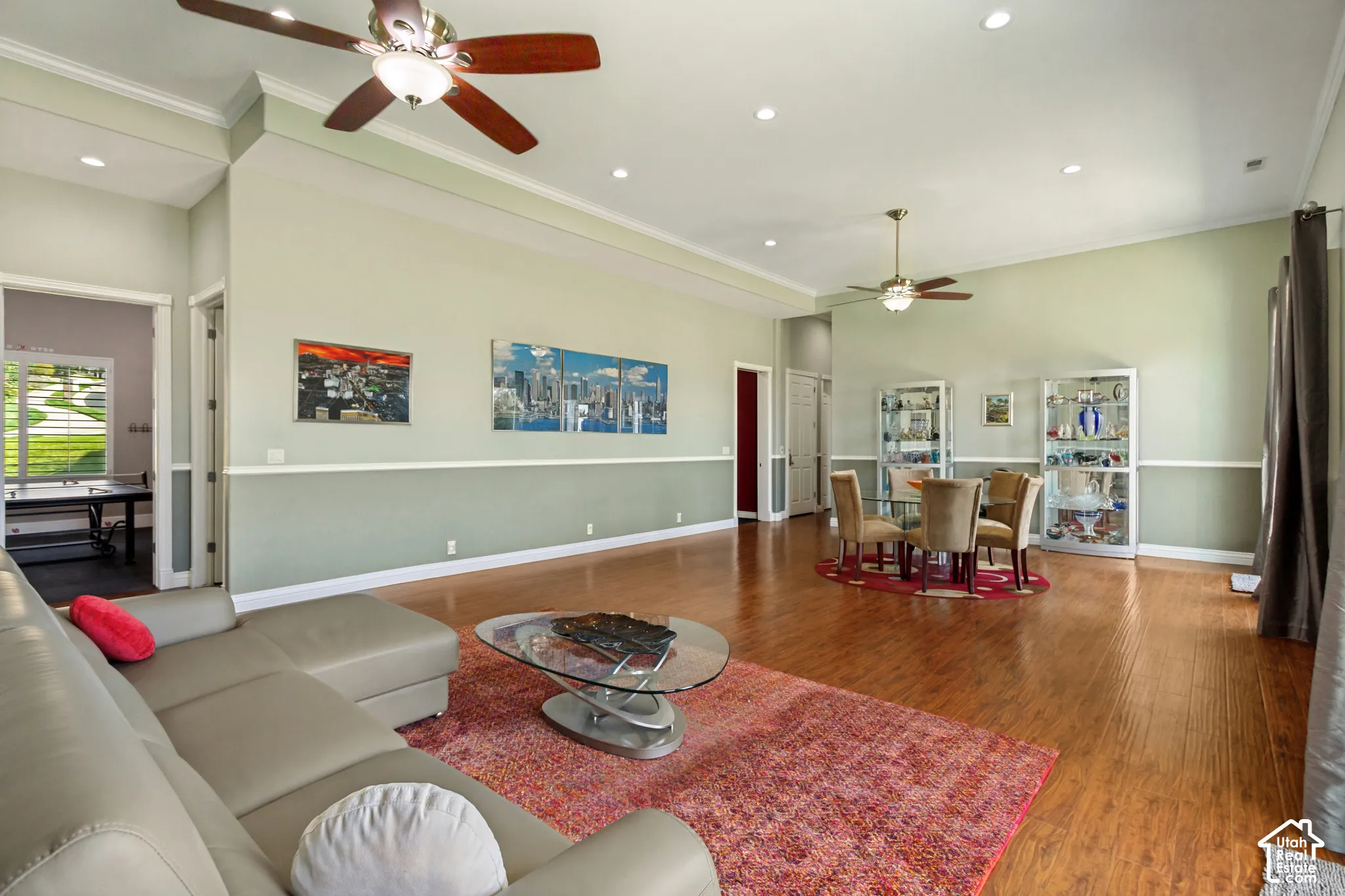 Expansive living area featuring wood-finish flooring, recessed lighting, and crown molding