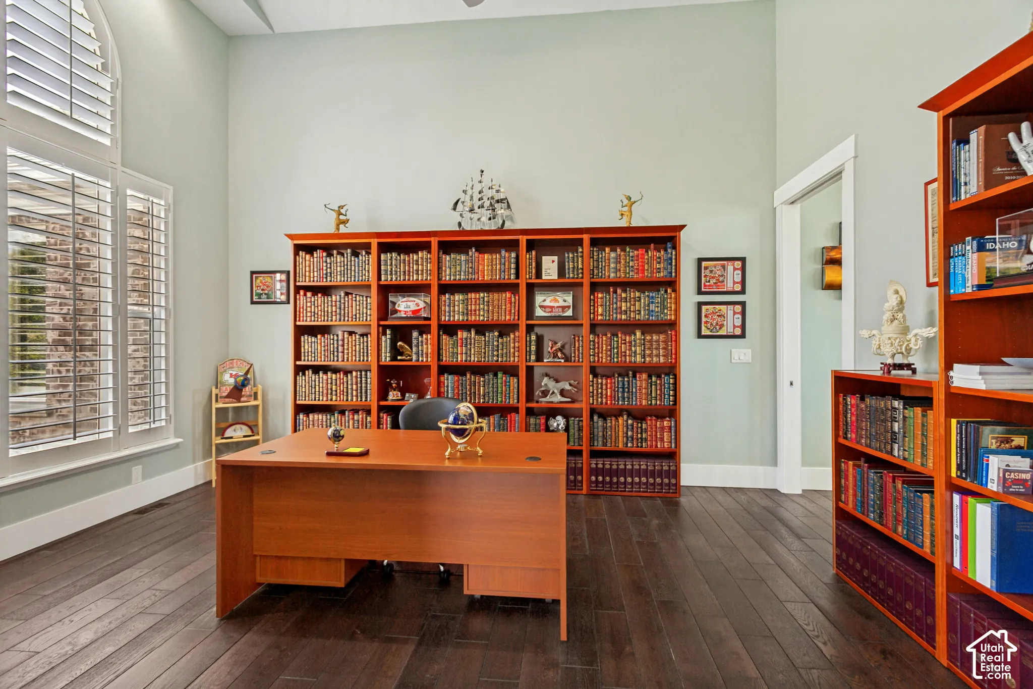Tall ceilings complemented by dark wood-finish flooring