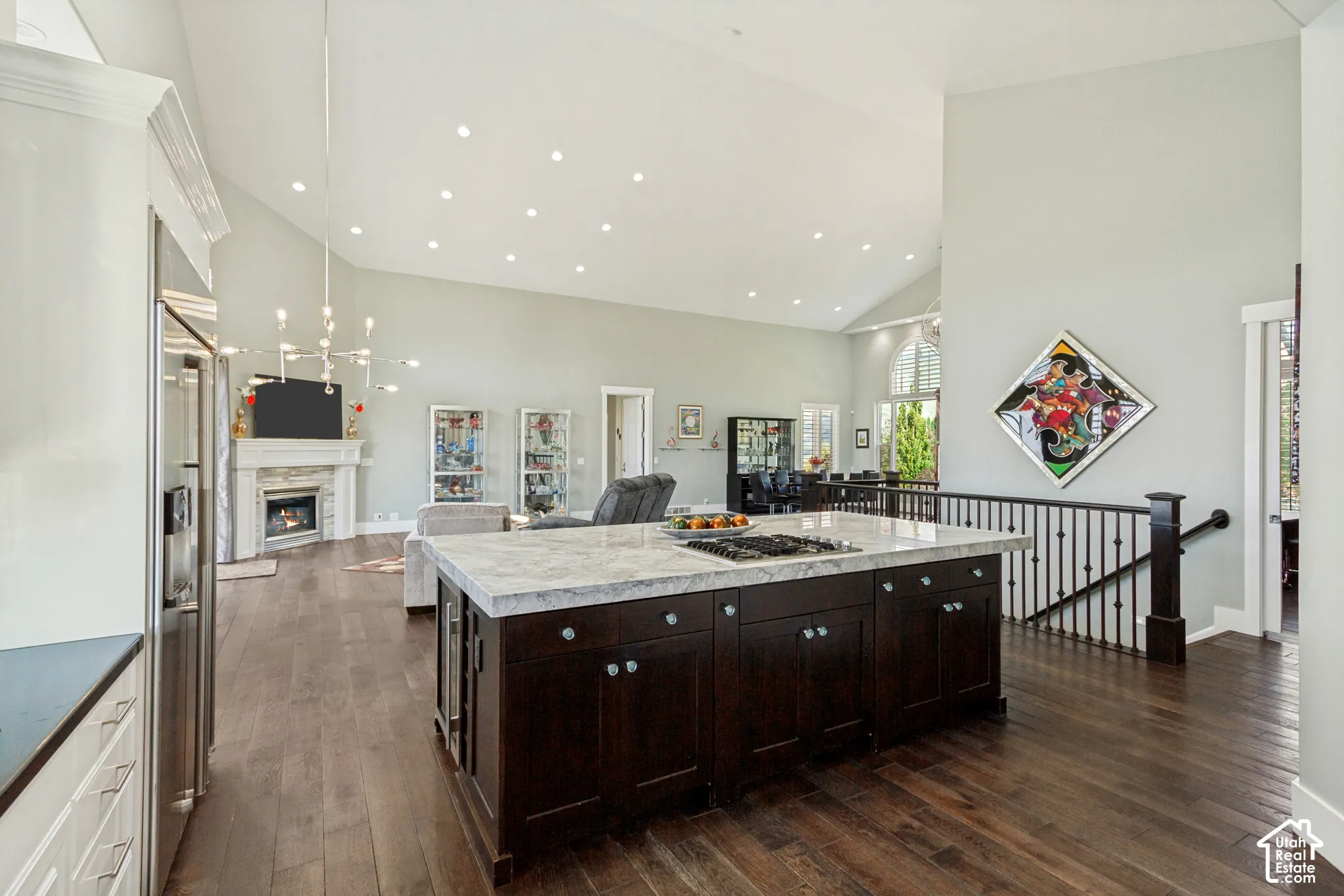 Spacious kitchen island with a built-in cooktop and granite countertop