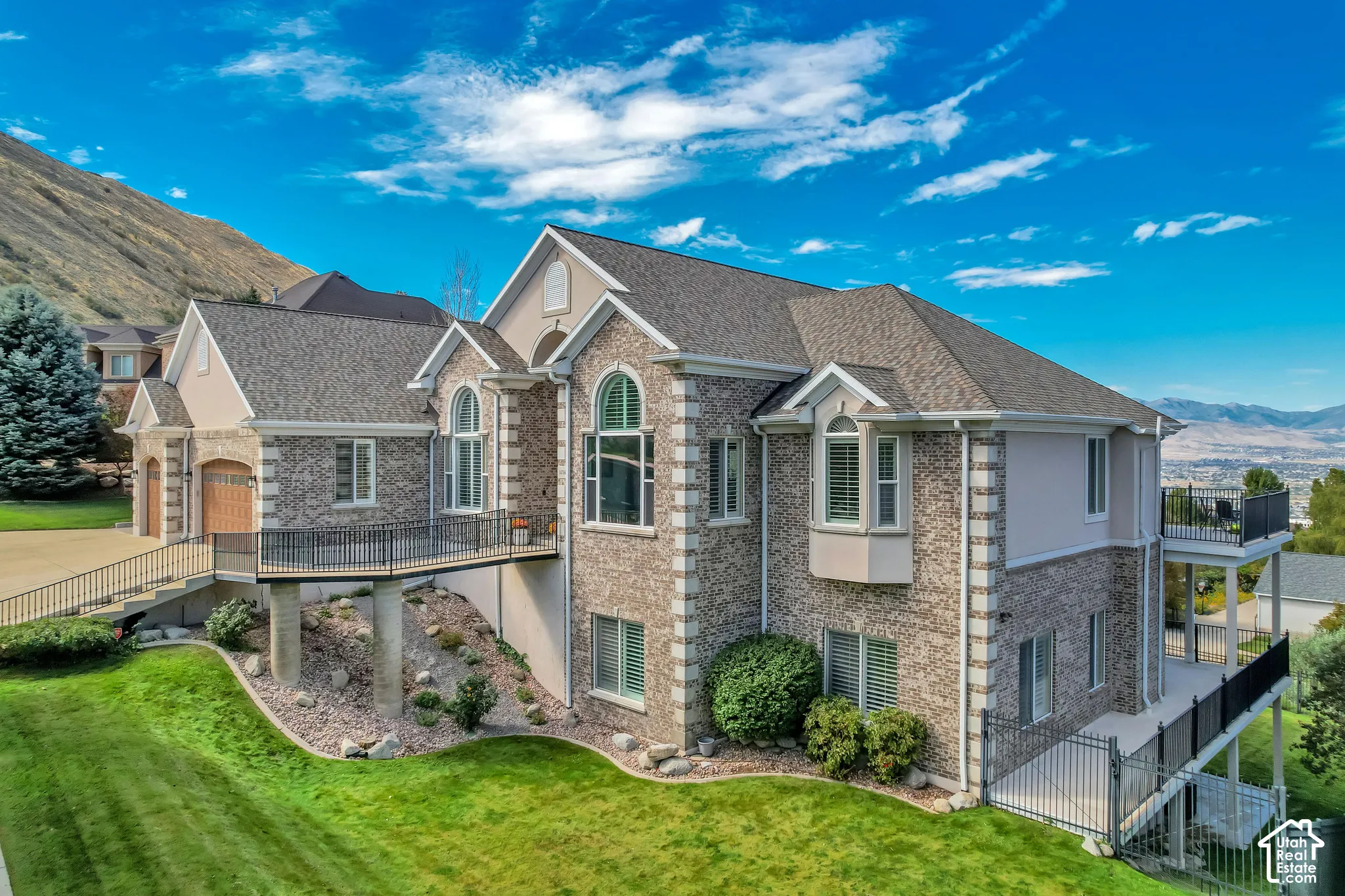 Brick and stucco exterior with multiple gabled roofs