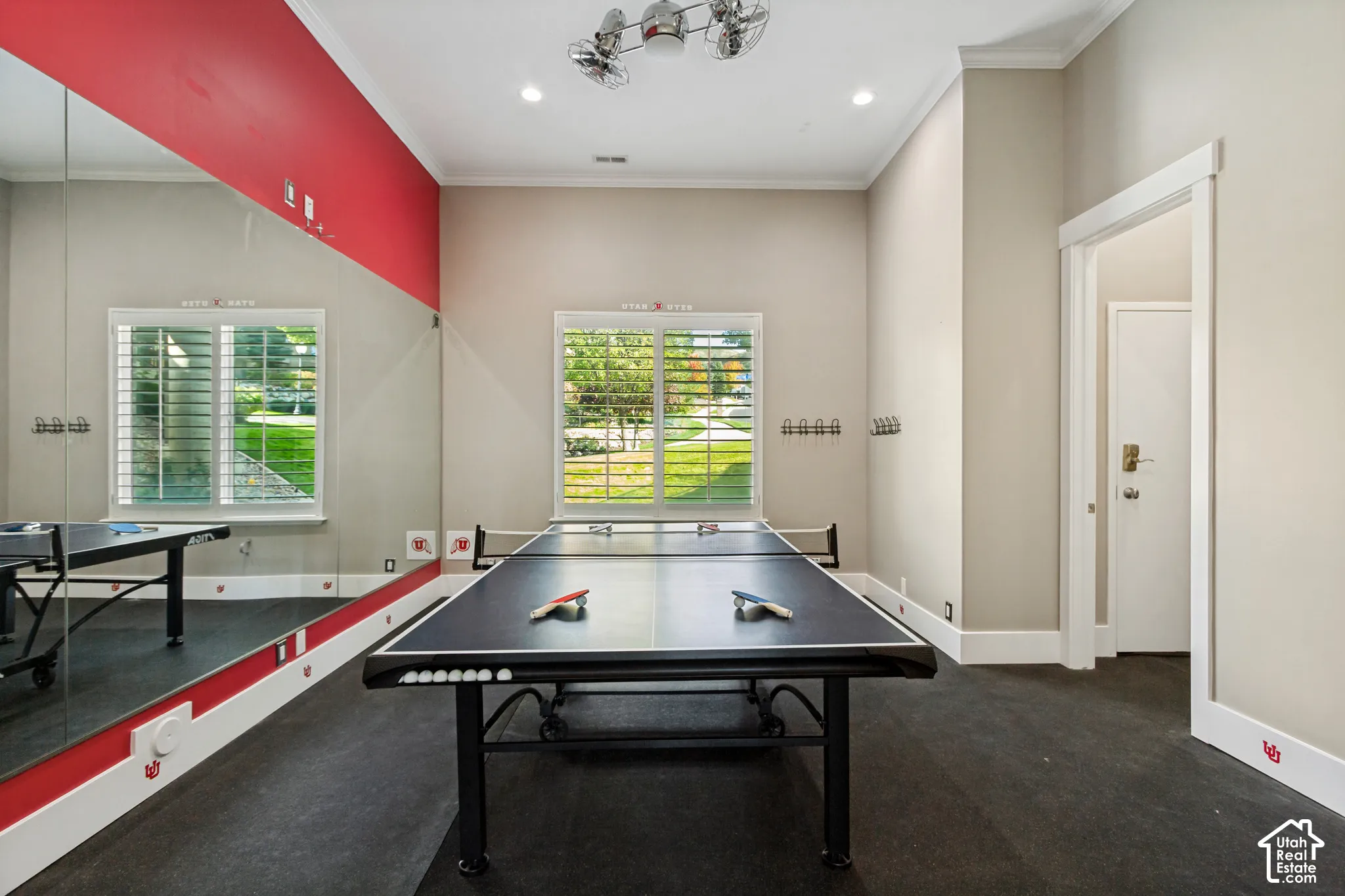 Recessed lighting, crown molding, plantation shutters, full-height wall mirror, and a ceiling fan