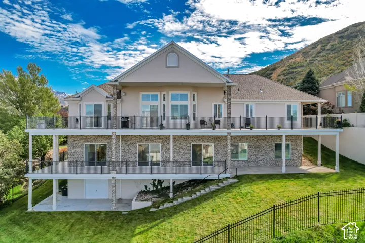 Multi-level rear facade featuring stucco and stone veneer