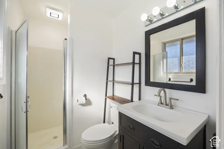 Modern bathroom featuring a floating vanity with white rectangular sink, chrome faucet, and dark cabinetry