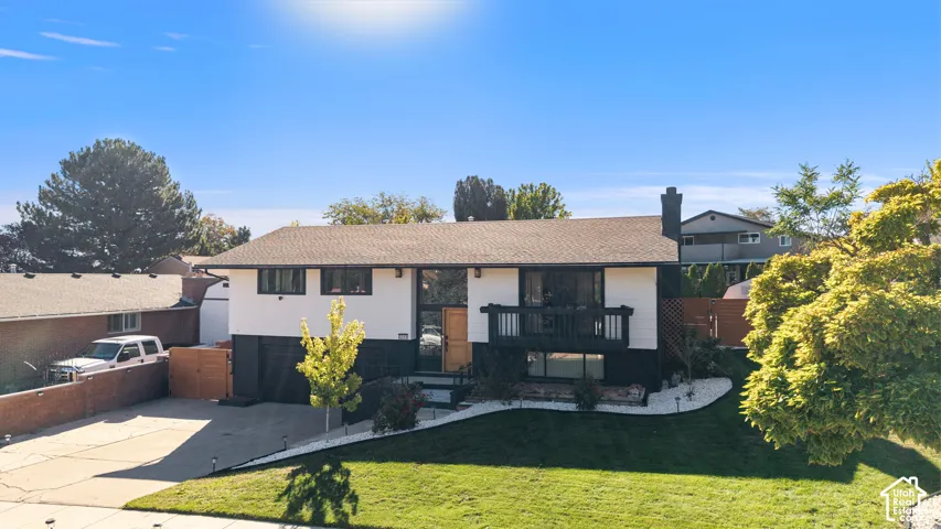 Two-story residence featuring a dark shingle roof and a two-tone exterior
