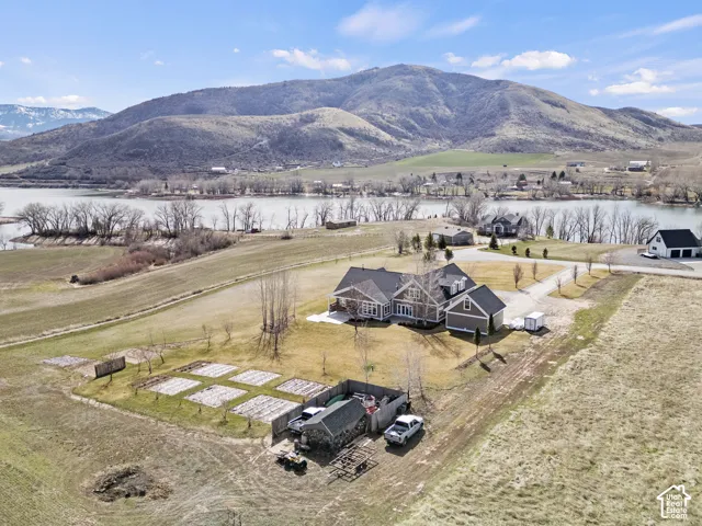 Expansive rural property featuring a contemporary home with dark exterior siding, situated on substantial acreage with mature landscaping and established trees