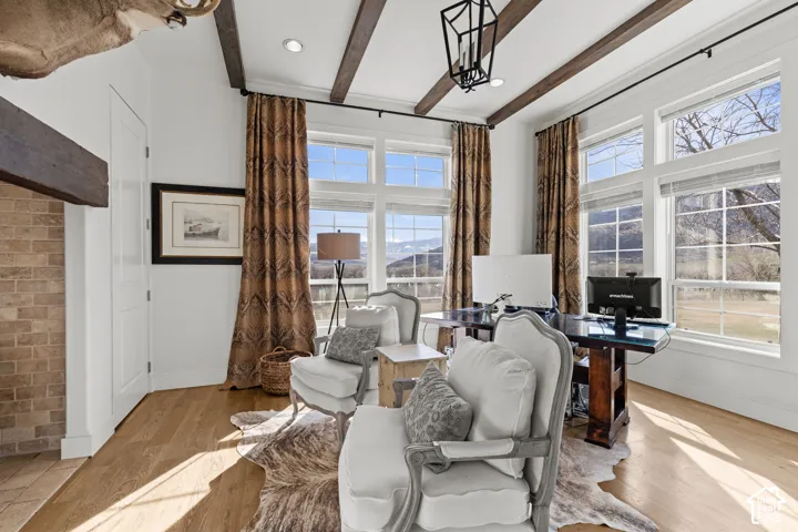 White walls with exposed ceiling beams and recessed lighting