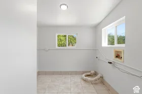 Recessed ceiling light, two windows, and tile flooring with a tile baseboard
