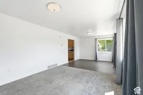 Bright interior with light walls, recessed lighting, and a large window