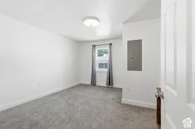 Recessed ceiling light fixture, neutral grey carpet, and window with natural light