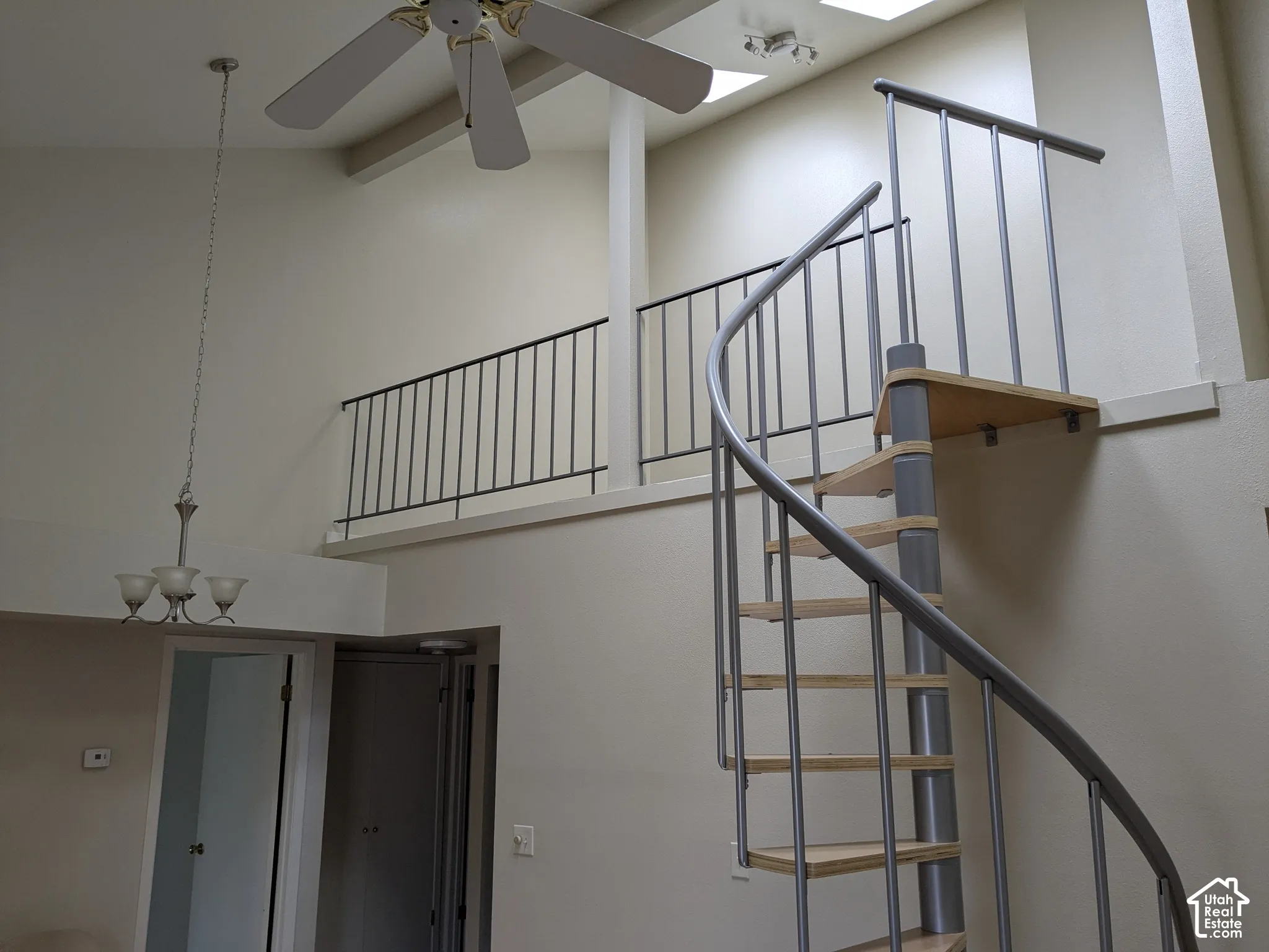Spiral staircase with wood-finish treads and metal railing