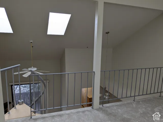 Vaulted ceiling with dual skylights and a ceiling fan