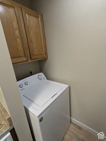 Wood-finish upper cabinetry provides storage