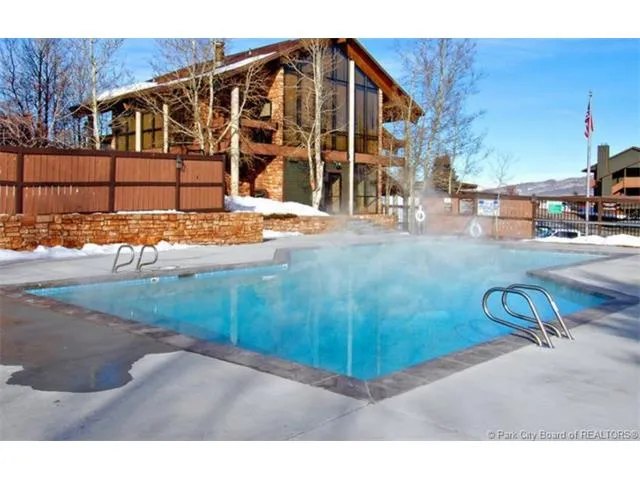 Outdoor rectangular pool with integrated entry steps and a concrete surround