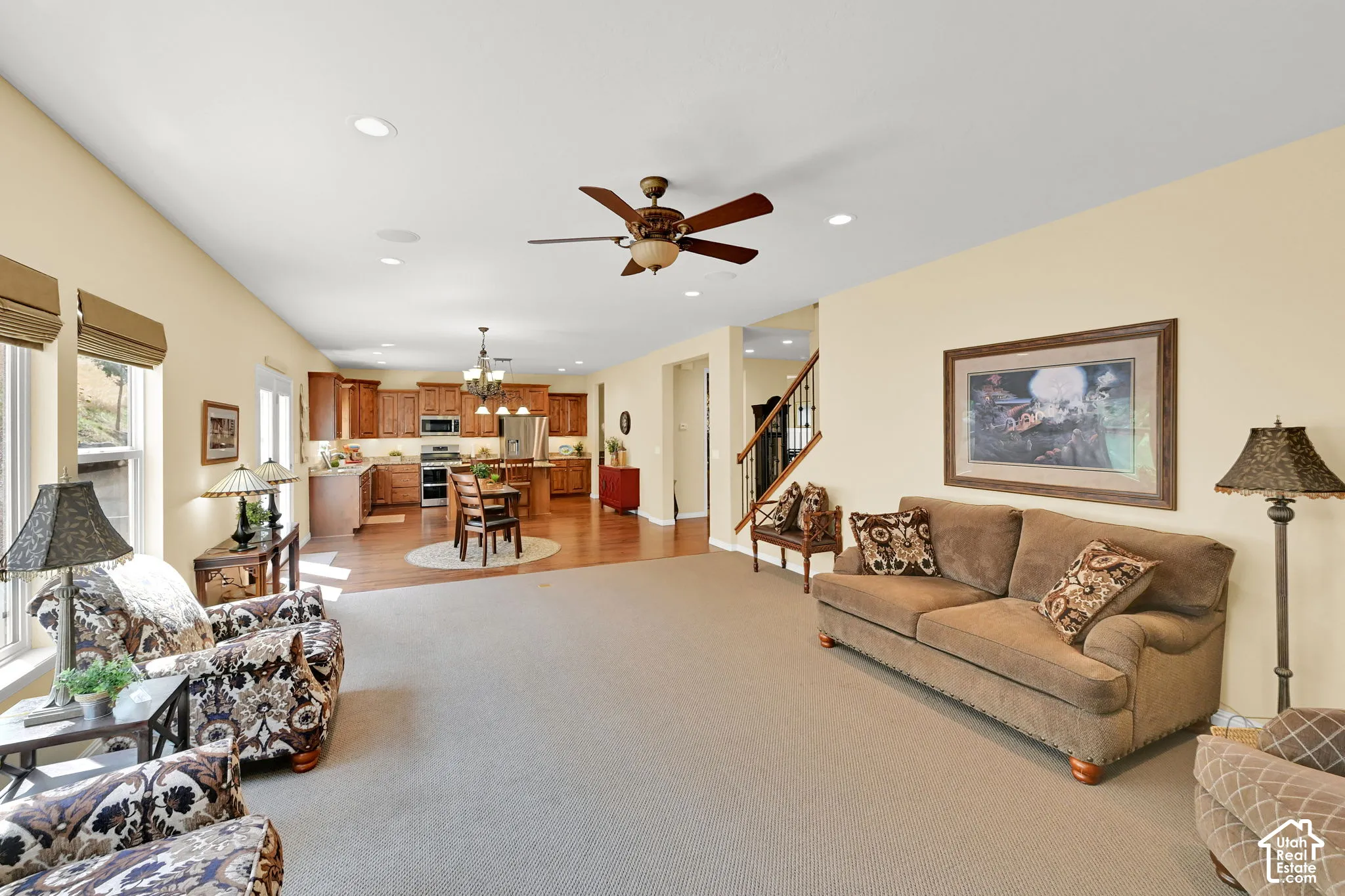 Open-concept living area with carpet flooring and recessed lighting