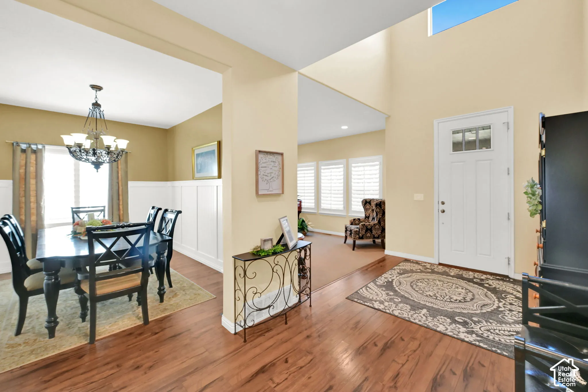 Two-story foyer with transom window and wood-finish flooring