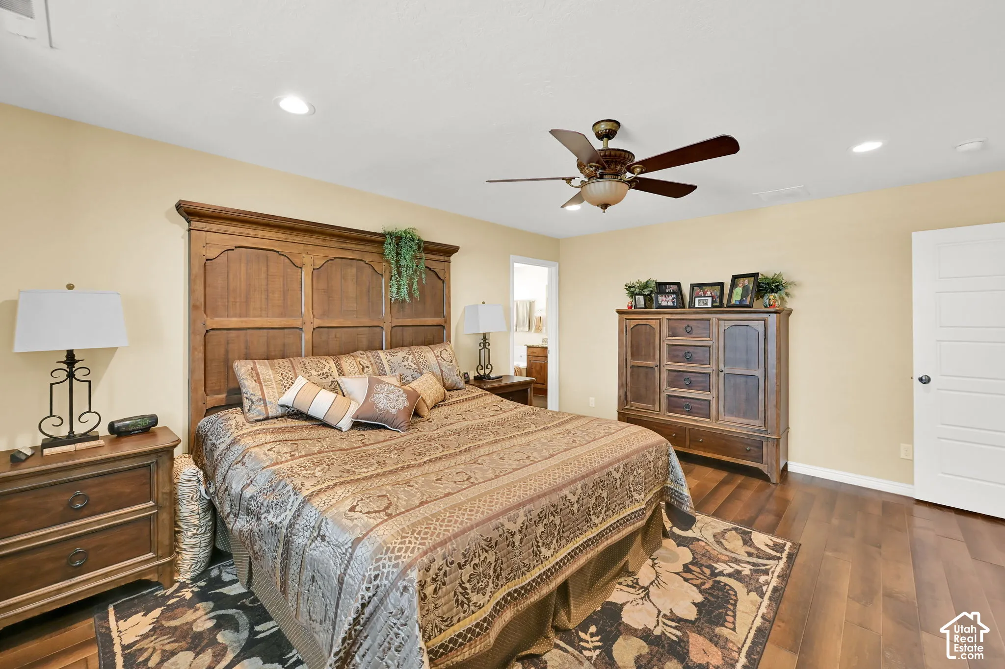 Hardwood-style flooring with recessed lighting and a ceiling fan
