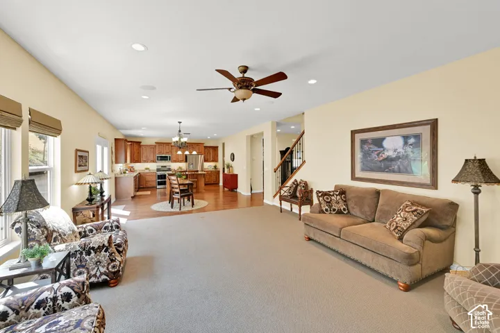Open-concept living area with carpet flooring and recessed lighting