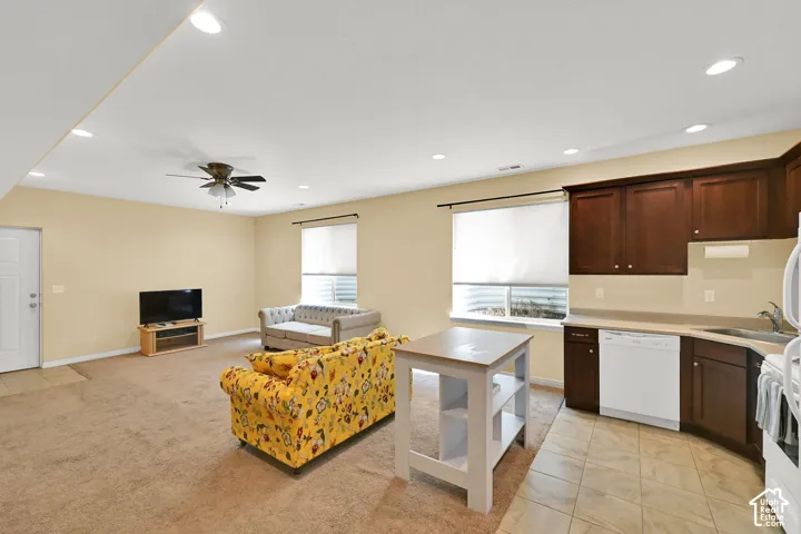 Open-concept living area featuring a ceiling fan and recessed lighting