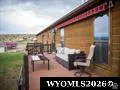 Real Estate Listing Photo. Depicting an exterior deck area with outdoor furniture and a portion of the property's structure