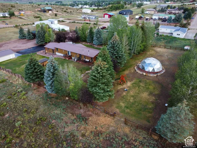 Single-story residence with a covered porch, detached garage, and a geodesic dome structure