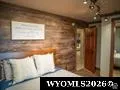 Wood-panel accent wall with overhead track lighting