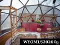 Real Estate Listing Photo. Interior view of a geodesic dome structure with visible framework and a red-colored feature