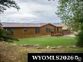 Real Estate Listing Photo. Exterior view of the property with surrounding vegetation and a visible MLS identifier