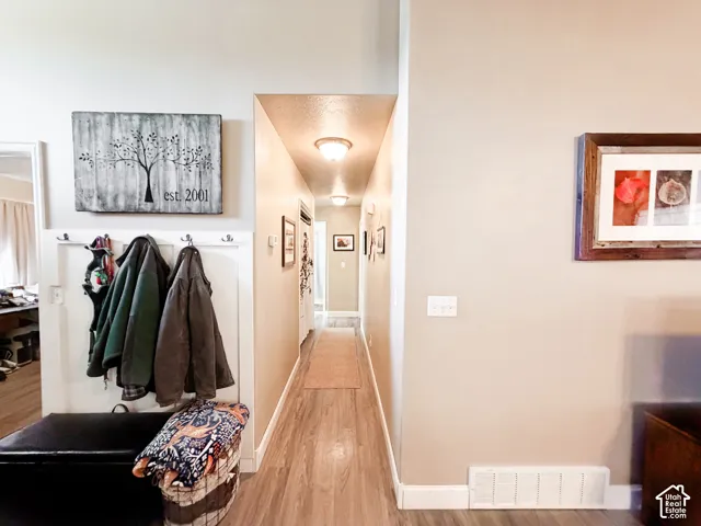 Wood-finish flooring throughout the hallway