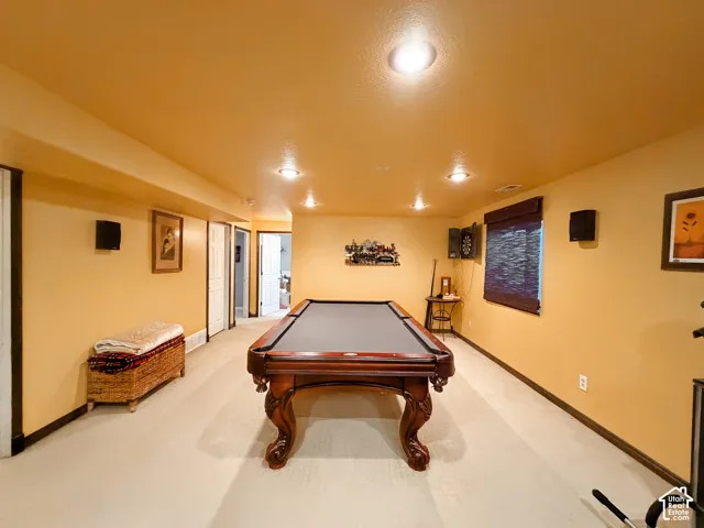Recessed lighting, wood-finish trim, light-colored carpeting, window with blinds