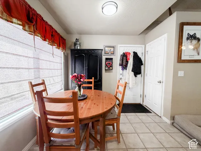 Light-toned tile flooring, light-colored walls, and a built-in recessed ceiling light