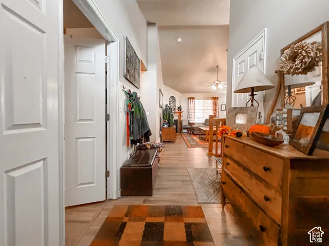 Vaulted ceilings, recessed lighting, wood-finish flooring, and a ceiling fan with light kit
