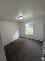 Neutral wall tones with dark-toned carpeting