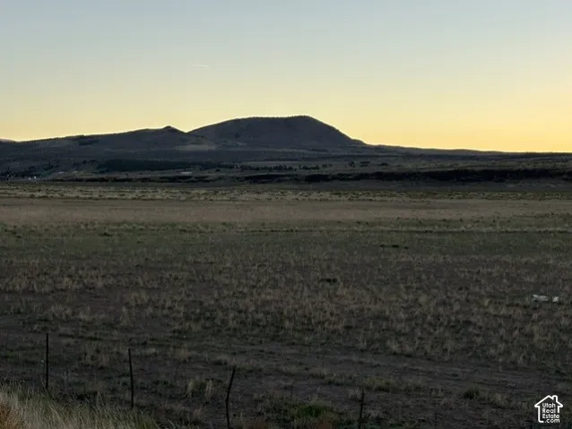 Expansive undeveloped land featuring natural terrain and distant mountainous backdrop