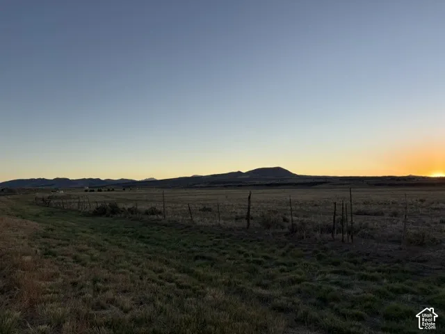 Expansive open field with distant mountain ranges
