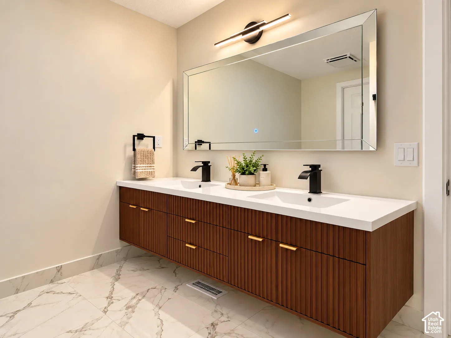Floating double vanity with a reeded wood-finish base, white countertop, and integrated sinks