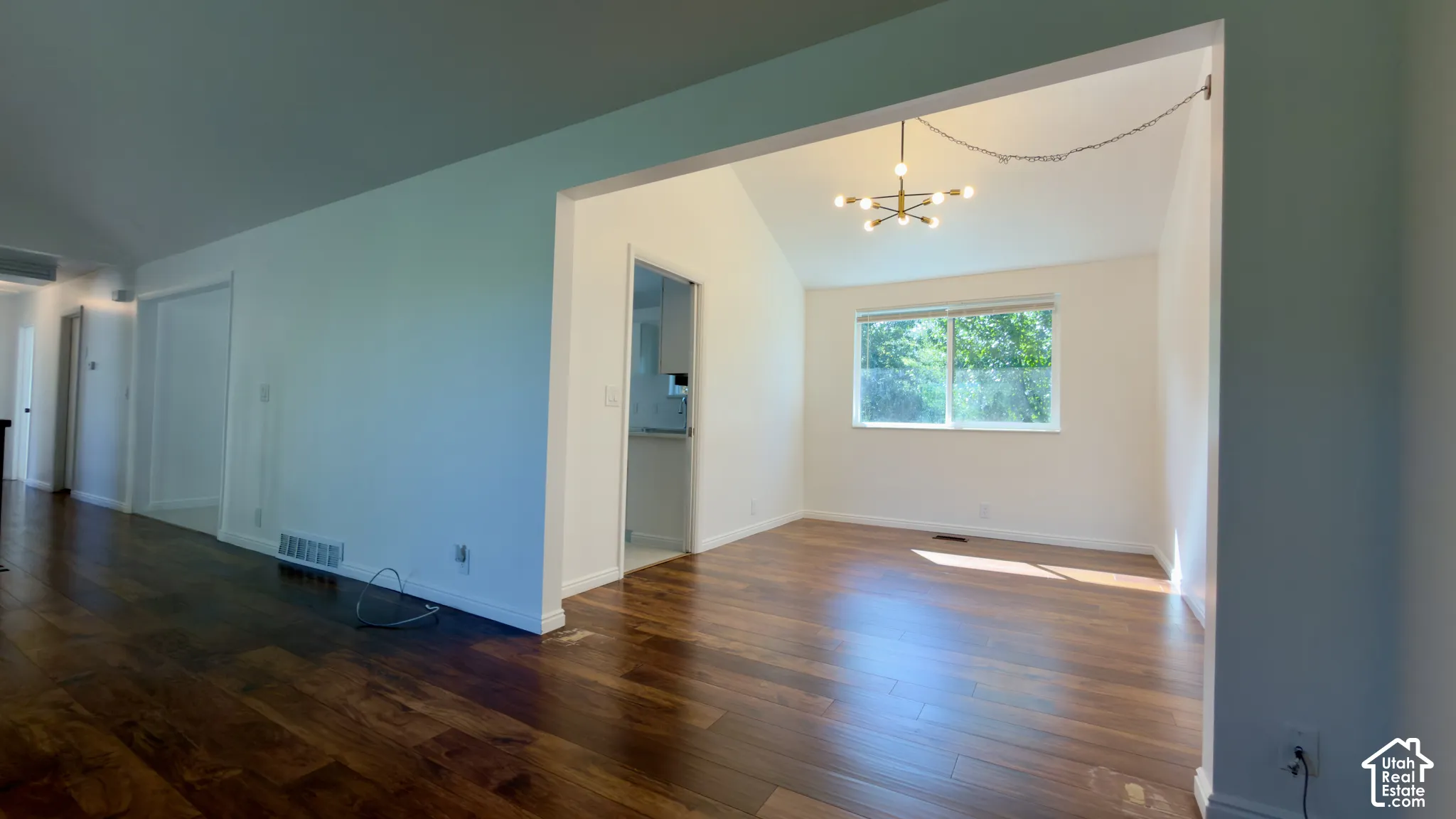 Wood-finish flooring throughout, vaulted ceiling, and recessed lighting