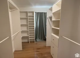Custom closet system featuring built-in shelving, hanging rods, and drawers