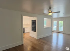 Wood-finish flooring throughout, with a ceiling fan and recessed lighting