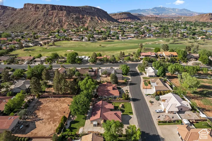 Community setting with established residential properties, mature landscaping, and prominent mountain backdrop