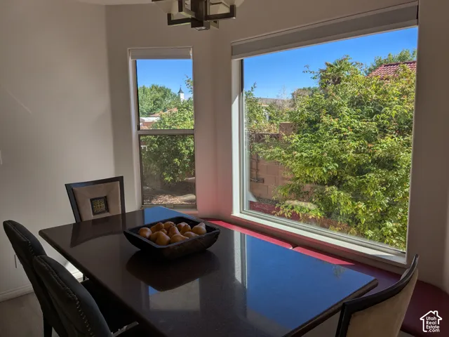 Built-in corner bench seating with coordinating window frames and a contemporary ceiling fixture